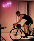 Dont Quit Neon Sign Do It LED Neon Light for Wall Decor USB powered lighting in gym with cyclist, pink white acrylic