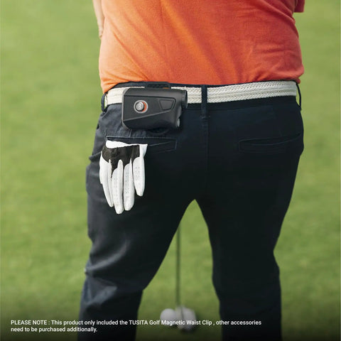 Golfer wearing heavy duty steel belt clip for magnetic golf rangefinders and accessories on white belt.