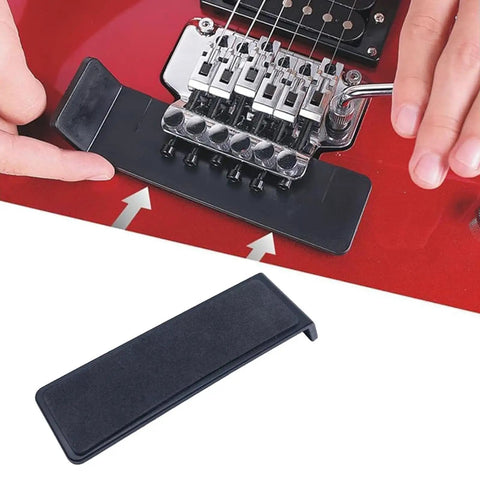 Slick Floating Tremolo Setup Blocks And Hella Smooth Sliders For Floyd Rose Electric Guitars with adjustment tool in use on red guitar.