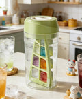 No Sweat Deep Chamber Ice Molds With Spin Top Silicone Lid Crafting Crisp Whiskey Cubes on a kitchen counter with drinks.