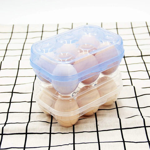 Stacked blue and clear Six Grid Egg Storage Box For Refrigerator And Camping with eggs on a checkered cloth.