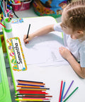 Child writing at desk with 50 Pack Hot Air Balloon Style Desk Nameplates For Students, colorful balloon decor with large writing area.