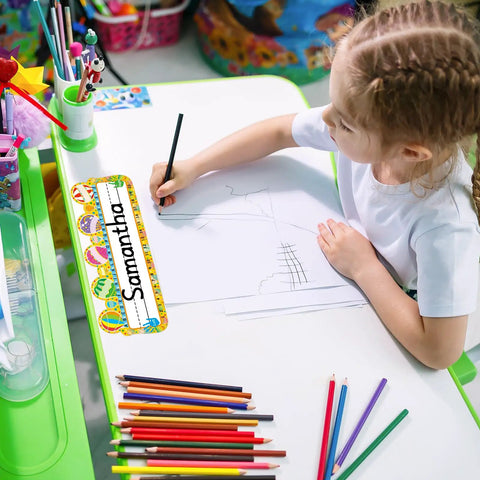Child writing at desk with 50 Pack Hot Air Balloon Style Desk Nameplates For Students, colorful balloon decor with large writing area.