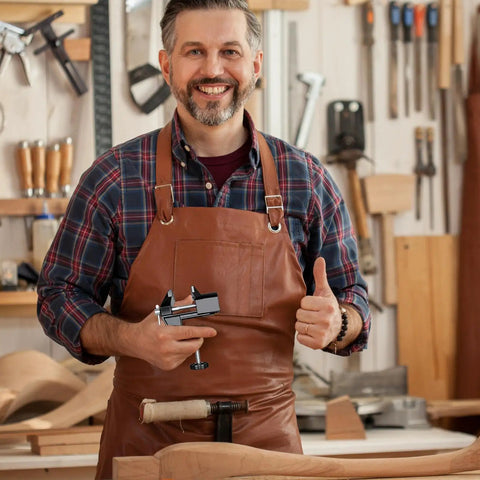 Man in leather apron holding Heavy Duty Mini Work Bench Vise With Adjustable Quick Release Clamp for DIY projects.