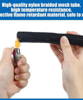 Person holding a lighter near a 50 Ft Split Wire Loom Tubing showcasing flame retardant material, safe for automotive use.