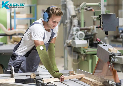 Man using woodworking tools wearing Top Shelf Kevlar Arm Sleeves With Thumb Holes Cut Scratch And Heat Resistant Long Arm Protective Guards.