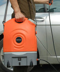 Man holding On The Go Portable Spray Washer With Built In Water Tank, Rechargeable Battery Or Car Or Home Plug, next to car