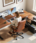 Person working at 55 Inch L Shaped Electric Standing Desk With Drawers And File Cabinet Sets For Home Office Sit Stand Computer Desk In Walnut And Black