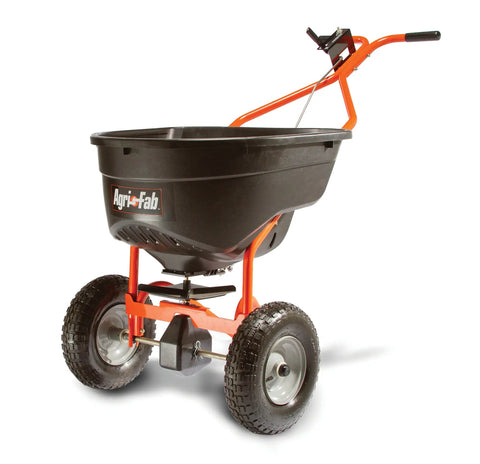 Big Yard Workhorse 130 Lb Walk Behind Lawn And Garden Broadcast Spreader with pneumatic tires in orange and black