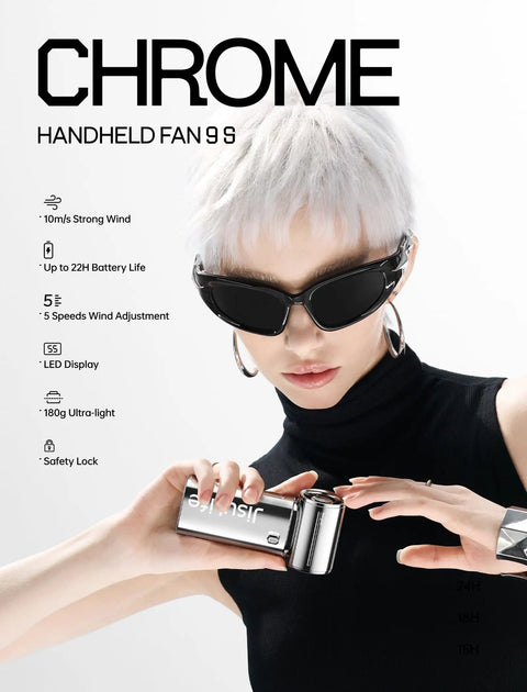 Person holding a Portable Handheld Turbo Fan With High Speed Air 22H Max Cooling Time 9 Blade Turbine, chrome finish, indoors.