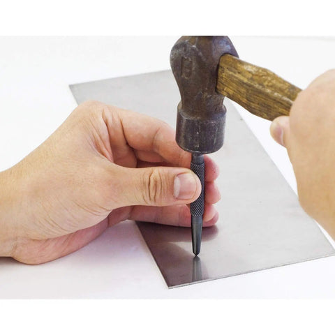 Using the Center Punch With Carbide Tip For Precise Marking Before Drilling on metal, showing 3 inch tool and hammer