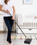 Woman using Electrostatic Carpet And Floor Sweeper Boasts A Nine Inch Cleaning Path For Tile And Rug on hardwood floor.