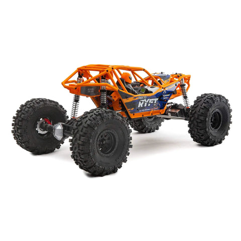 RBX10 Ryft 4WD Brushless RC Rock Bouncer Ready To Run Beast On The Trail With Solid Front And Rear Axles Rugged Tube Chassis 4S Capable Powertrain Licensed Raceline Wheels Battery And Charger Not Included, showing side view with orange chassis and large tires.