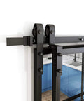 Close-up of Bypass Double Glass Barn Door Kit With 6.6 Ft Hardware, clear tempered glass panels, aluminum frame, installed in kitchen