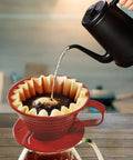Pouring hot water into coffee dripper with Disposable Coffee Filters For 1 To 4 Cup Basket Makers, Natural Brown Unbleached, 100 Count Pack