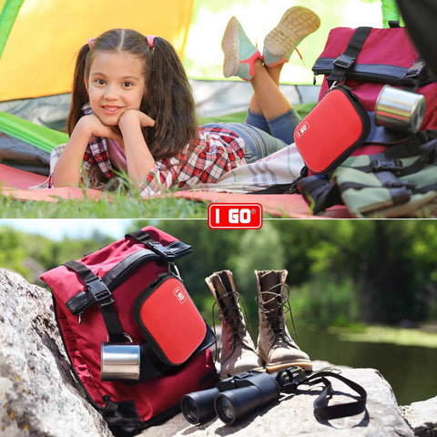 I GO red hard-shell compact first aid kit attached to a red hiking backpack; camping gear nearby.