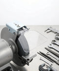 WRITWAA 2-Pack Industrial Bench Grinder Eye Shield Guard mounted on a heavy-duty grinder, protecting against sparks and debris.