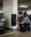 Man installing Heavy Duty Self Adhesive Garage Wall Corner Guard With Thick Eva Foam Pad to protect vehicle from scrapes.