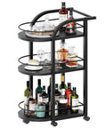 Black Three Tier Rolling Bar Cart Featuring Sturdy Safety Rails And Smooth Swivel Casters Crafted To Hold Your Goodies Squad Approved For Backyard Hangouts And Casual Kickbacks with drinks and glassware.