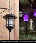Six Pack Solar Flame Torch Lights Outdoor Dual Use Flickering Purple Flame Garden Lanterns Auto On Off Waterproof Halloween Lighting on wooden wall and lawn