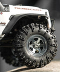 Close-up of 36x14mm 0.7 Inch Swamp Claw RC Tires For 1/30 Axial SCX30 with Soft Sticky S5 Compound on rocky terrain.