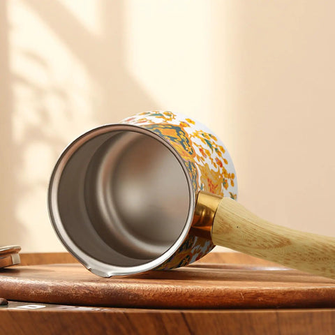 Bottom view of Turkish Greek Arabic Stovetop Coffee Pot With Milk Warmer 550 ML, white with gold flower pattern, wooden handle.
