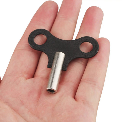 Hand holding Two Pack 4.5mm Clock Winding Keys For Antique Wall Clocks And Alarm Clocks, Durable Steel Winder Set With 0.177 Inch Hole