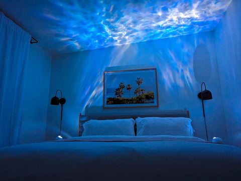 Bedroom with blue LED sky projections from Sky Lite Evolve LED Galaxy Cloud Projector With Wi Fi Ambient Night Light Remote Control Black Finish