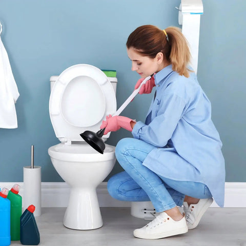 Woman using Top Shelf Heavy Duty 12 Pack Toilet Plungers with long grip handle to unclog toilet in bathroom.