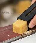 Pro Grade Natural Rubber Sandpaper Cleaning Stick in use on sanding belt with stainless steel tip visible