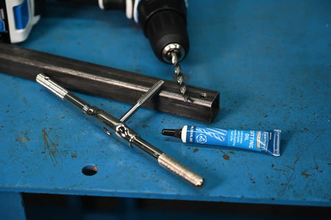 Pro Grade Metric Plug Tap and H Drill Set in High Carbon Steel 8.0mm by 1.25 Pitch on blue workbench with cutting oil