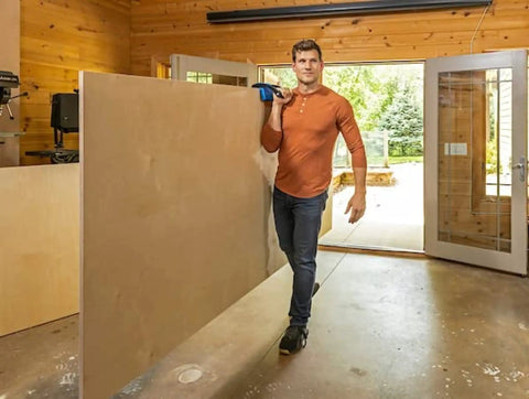 Person using Panel Carrier For Plywood Sheets And Large Panels With Ergonomic Grip One Handed Carry Up To 100 Lbs Heavy Duty Tool indoors