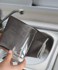Person cleaning glass with Grey 16x16 inch Fish Scale Microfiber Cleaning Cloths For Glass And Mirrors, Lint Free, Streak Free