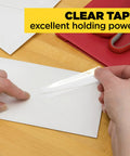 Clear Portable Tape For Office And Home, Versatile Transparent Adhesive On Four Dispensing Rolls, Three Quarter Inch By Eight Hundred Fifty Inches Each, Glossy Finish That Sticks Instantly On Glass, Plastic, And Paper being used to seal an envelope on a wooden desk with scissors in the background.