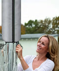 Person using Rotating Washing Line Cover With Waterproof Zip Closure For All Season Outdoor Use And Easy No Fuss One Handed Setup Protects Tumble Dryers