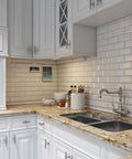 Under Cabinet Modular Track System 18 Inch White Space Saver in a modern kitchen with marble counters and white cabinetry.