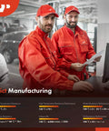 Two mechanics in red uniforms reviewing documents in an auto repair shop.