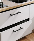 Matte Black Cabinet Pulls 5 Inch Center To Center Zinc Alloy Kitchen Handles on white drawers, installed in modern kitchen setting