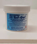 Front view of Tef-Gel 2 Oz Anti-Seize Lubricant With PTFE For Marine Hardware And Rigging, white container with blue label.