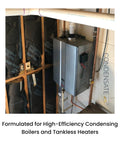 CondensateRx condensate neutralizer unit, silver metal box mounted on a wall beside copper piping.