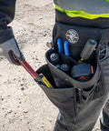Electrician's Padded Tool Belt And Pouch Combo with tools in 11-Pocket 4-Piece Set, worn by a professional outdoors.