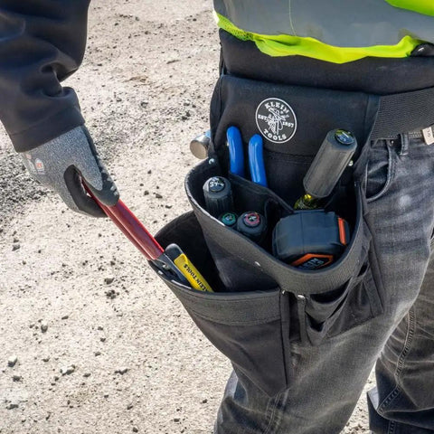 Electrician's Padded Tool Belt And Pouch Combo with tools in 11-Pocket 4-Piece Set, worn by a professional outdoors.