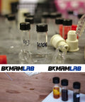 Snag A Solid Stack Of Thirty Dope Little Glass Vials Perfect For Mixing Essential Oils Or Bottling Custom Perfumes With Secure Screw Caps That Stay Leak Free During Travel And Keep Your Favorites Fresh, displayed on a lab table.