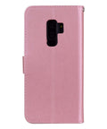 Pink leather phone case with camera cutout, standing upright, showcasing durable material and precise design for smartphone protection.