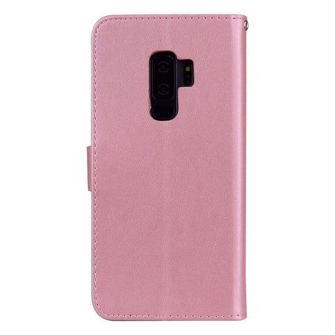 Pink leather phone case with camera cutout, standing upright, showcasing durable material and precise design for smartphone protection.