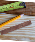 Top Shelf Wood Pen Blanks For Turning 8 Pack Exotic Lumber With Sick Rotating Grain Pattern Killer DIY Kit on wooden surface with measuring tape and pencil.
