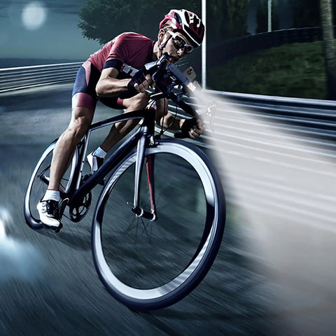 Cyclist using Beefed-Up 2400 Lumen Bicycle Headlight with 10000mAh Battery Pack on road at night