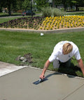 Worker using Pro Grade Finishing Trowel 16 By 4 Inch With High Carbon Steel Blade DuraSoft Curved Handle on concrete sidewalk