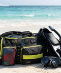 Premium Scuba Mesh Gear Bag for Big Gear, Extra Large 100L Dive Backpack With Reinforced Bottom on beach with diving gear