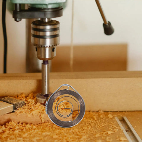 2pcs Heavy Duty Steel Drill Coil Springs Built For Durability And Elasticity Perfect Replacement For Milling Machines And Drilling Equipment Easy Installation Ensures Stability In Industrial Mechanical Workflows on a drill with shavings.
